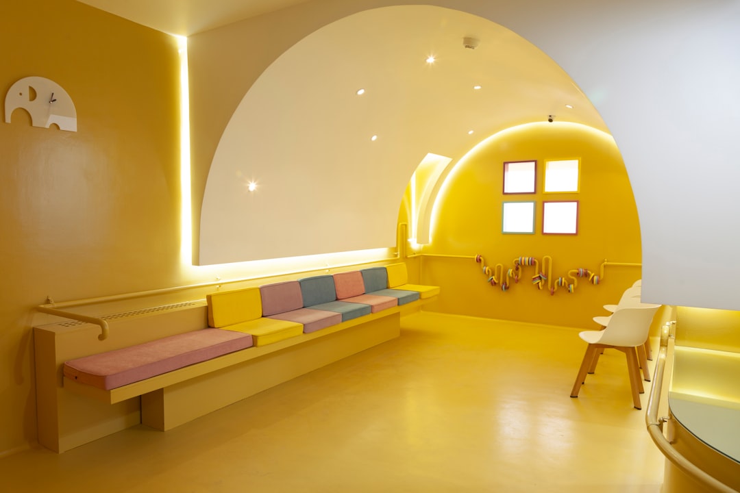 Comfortable waiting area with child-friendly corner and warm natural lighting